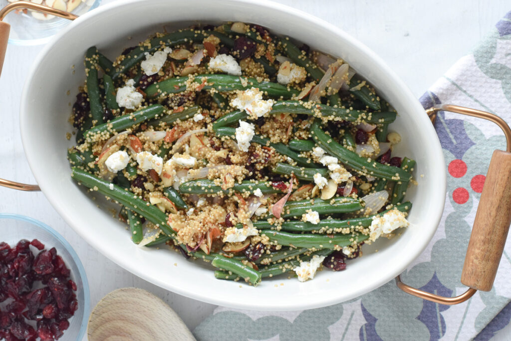 cranberry green beans with goat cheese in serving dish