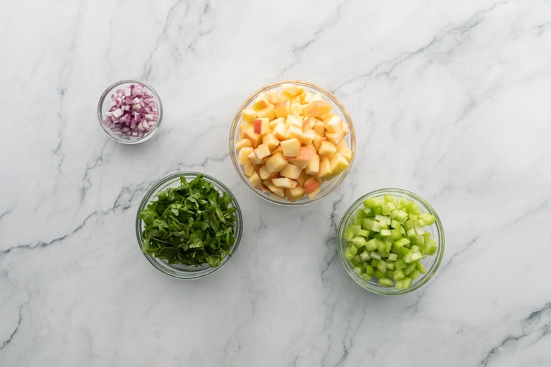 sliced veggies in clear bowls