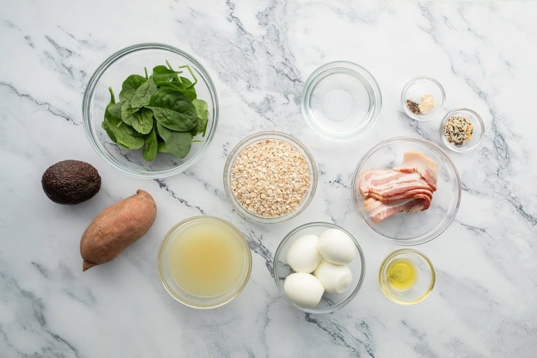 Ingredients for savory oatmeal bowl on granite countertop