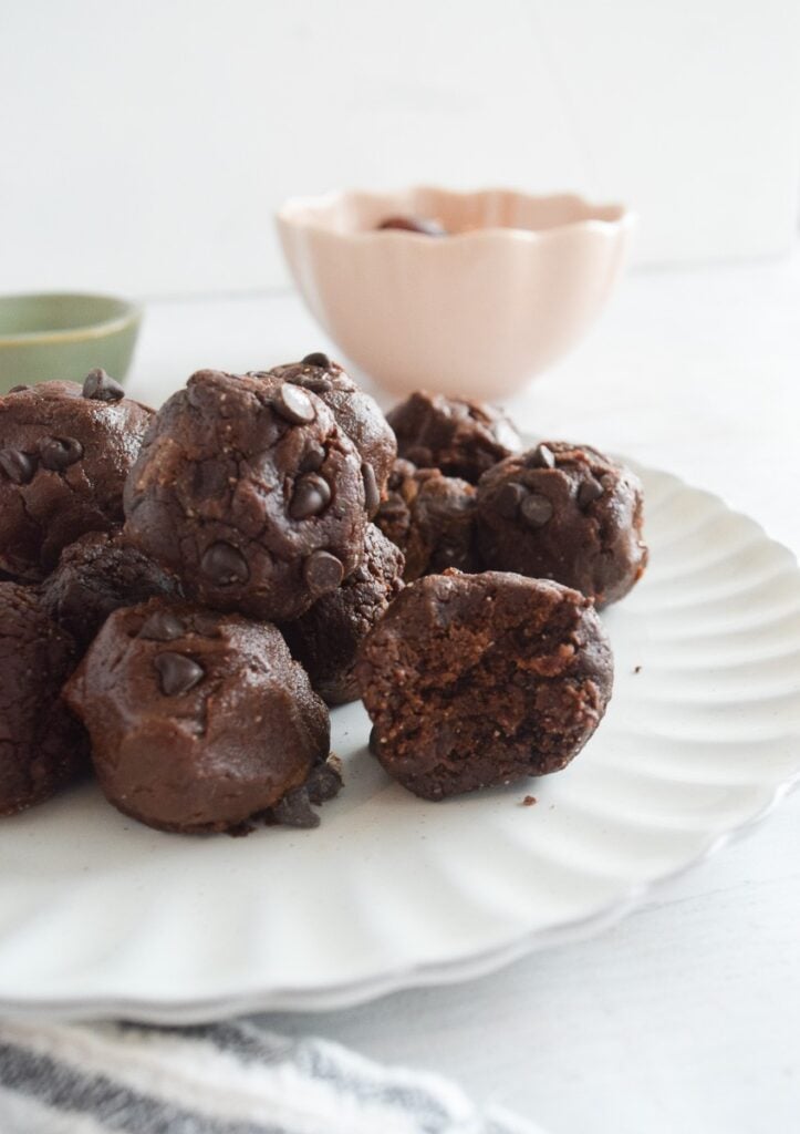 brownie batter protein balls with chocolate chips on white plate