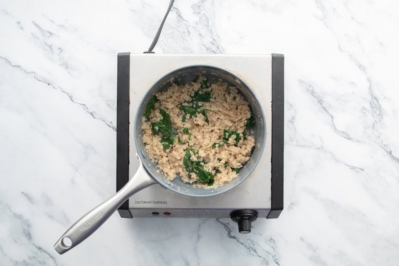 savory oats on stove with added veggies