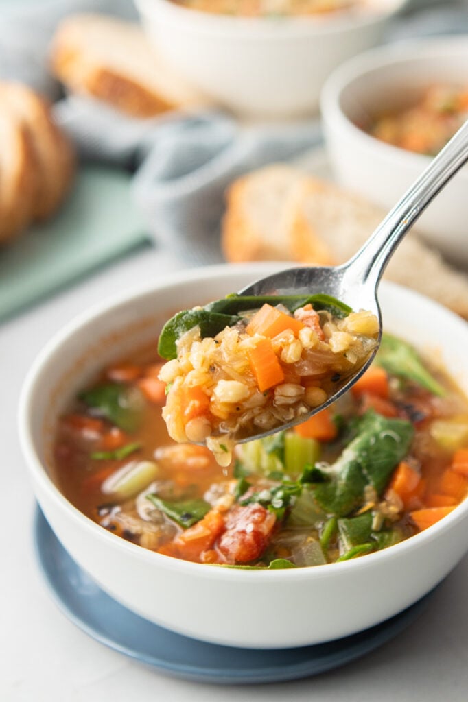 Healthy barley vegetable soup with lentils and fresh vegetables.