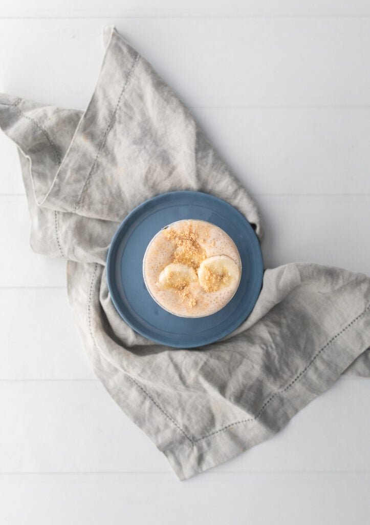 overhead shot of banana cottage cheese smoothie with sliced bananas