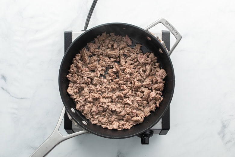 cooked ground pork in cooking skillet