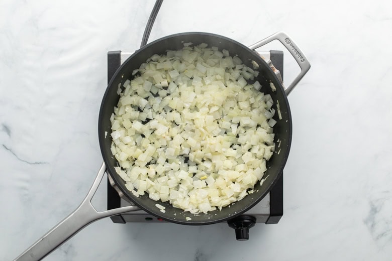 Sauteed onions on cooking pan for a stir fry