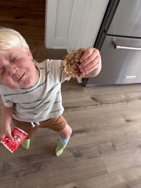 toddler holding homemade oatmeal date bar