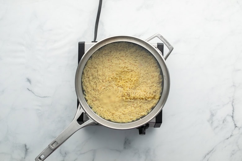 lemon orzo shrimp dish in cooking skillet