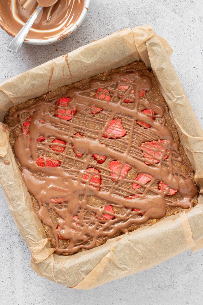 date oat bars with drizzled chocolate and freeze dried strawberries