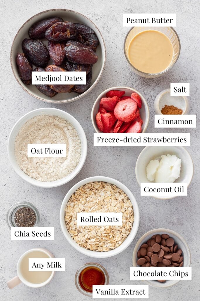 labeled ingredients in white bowls for oatmeal and date bars 