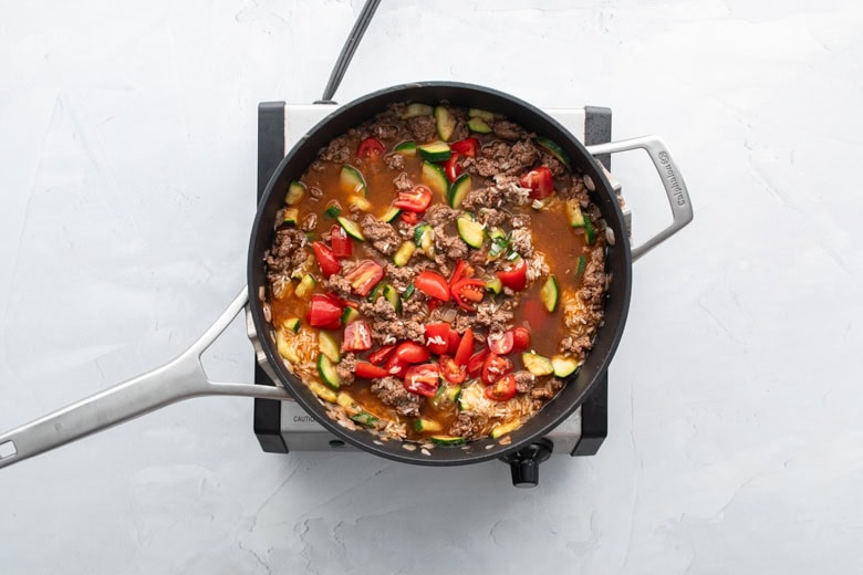 Ground beef and rice skillet with veggies, tomatoes and beef broth.