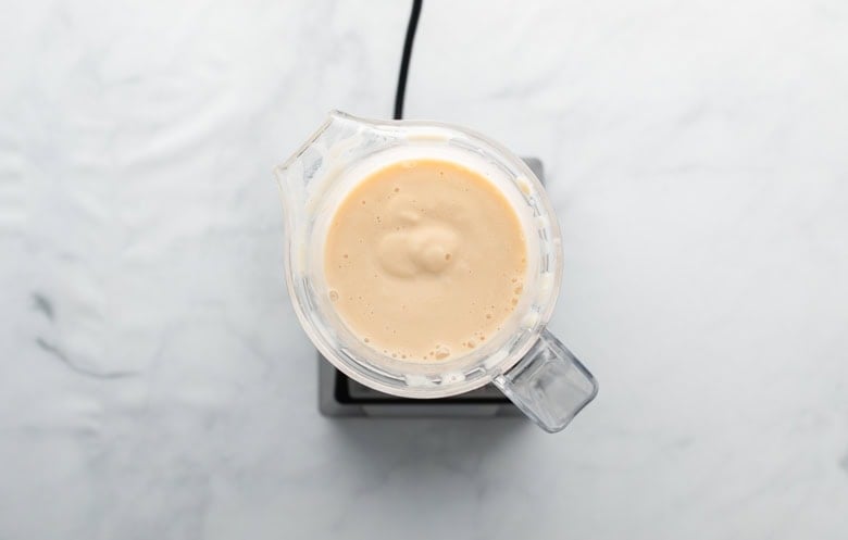 creamy peach and banana smoothie blended in blender