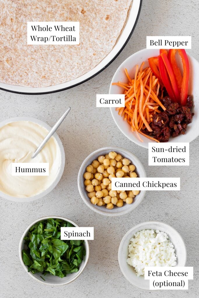 individual white bowls labeled with ingredients for hummus pinwheels