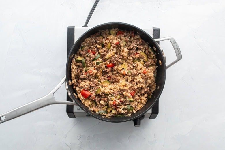 A delicious cheesy ground beef and rice skillet with colorful vegetables, ready to serve.