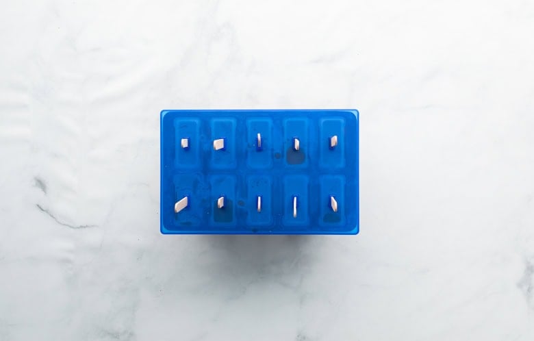 popsicle molds into freezer