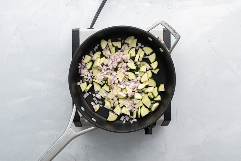 Dice your zucchini and shallots and saute them over medium-high heat in olive oil.
