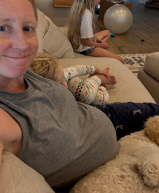 pregnant woman sitting on couch relaxing