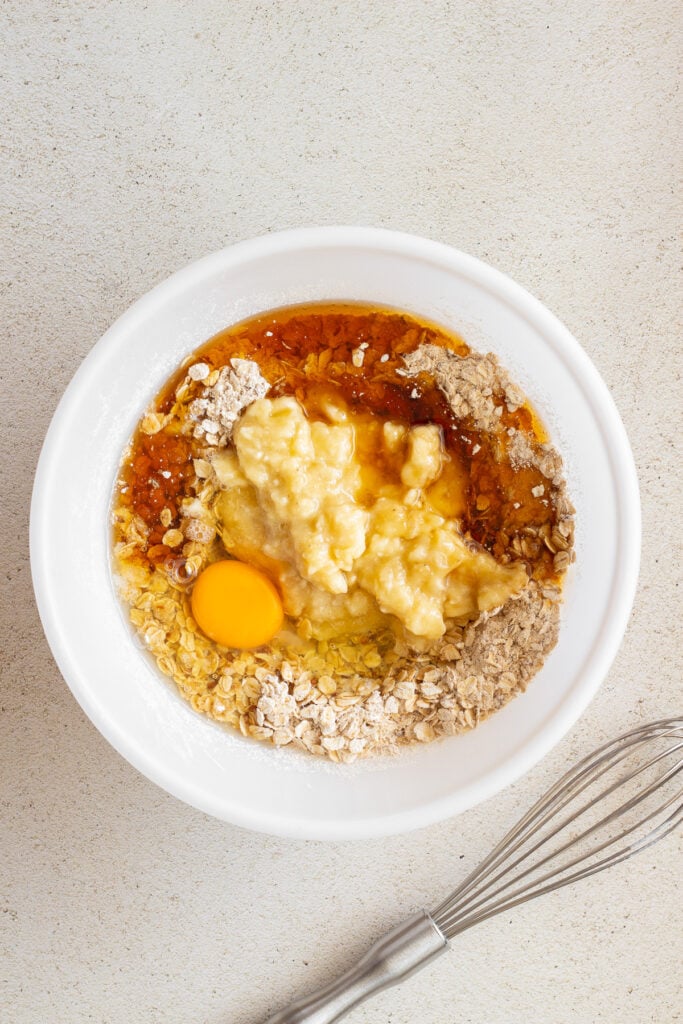 adding wet to dry ingredients in white bowl