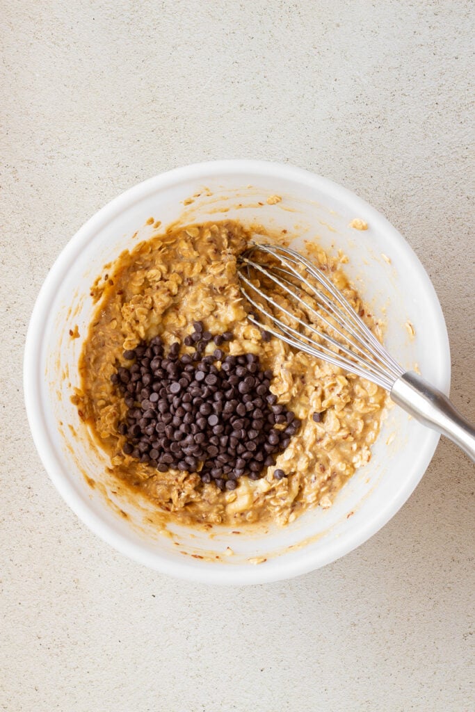 adding chocolate chips to banana chocolate chip oat bars batter