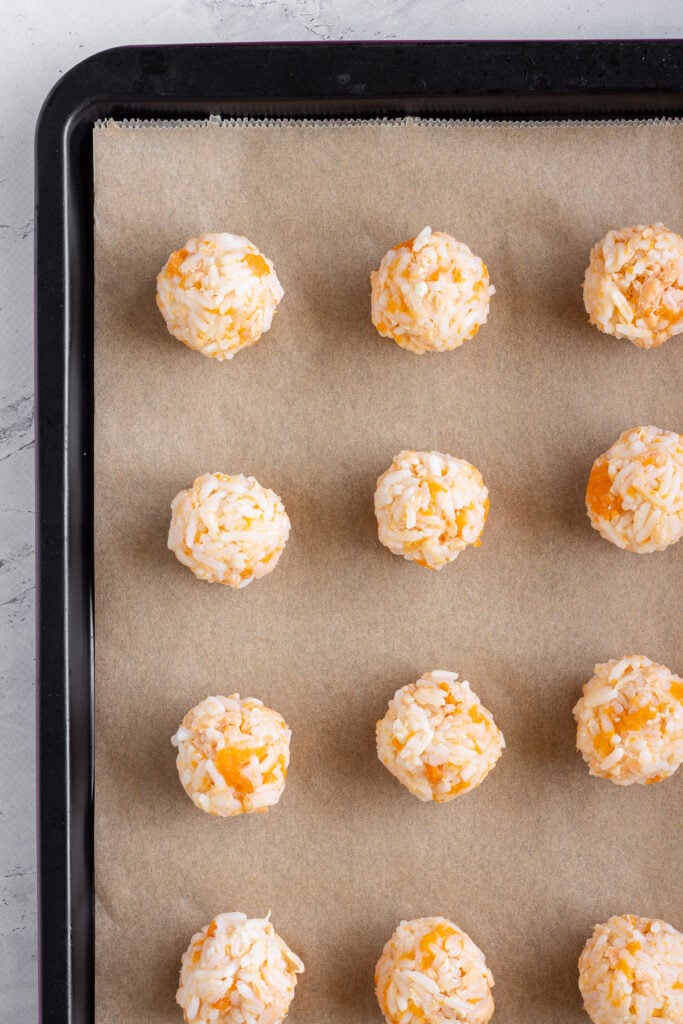 rolled canned salmon rice balls on parchment paper