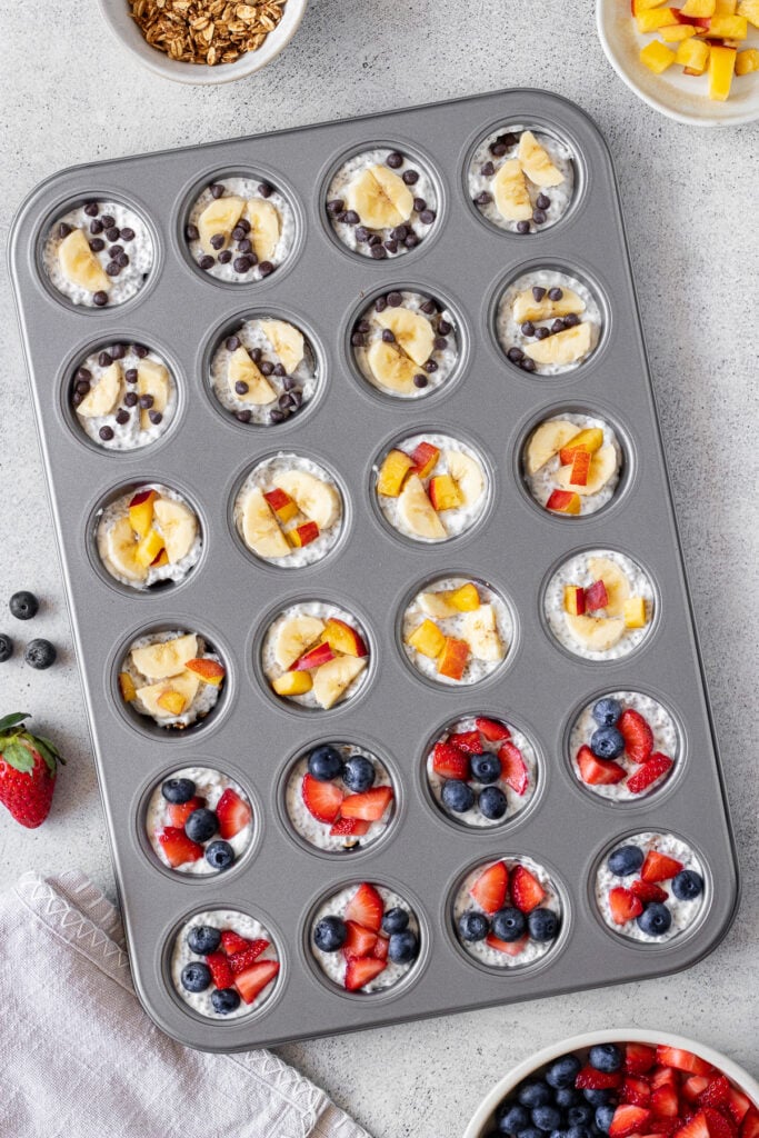 frozen greek yogurt bites recipe in mini muffin tin with fruit on top