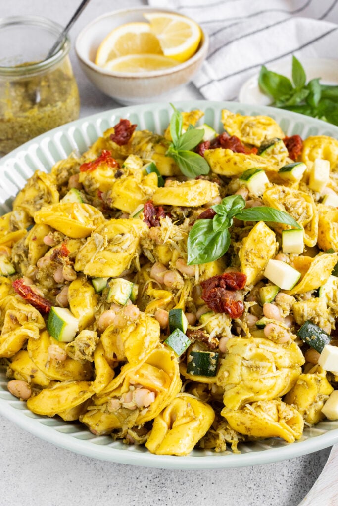 Delicious high protein tortellini pesto pasta salad with white beans, fresh basil and sun-dried tomatoes.