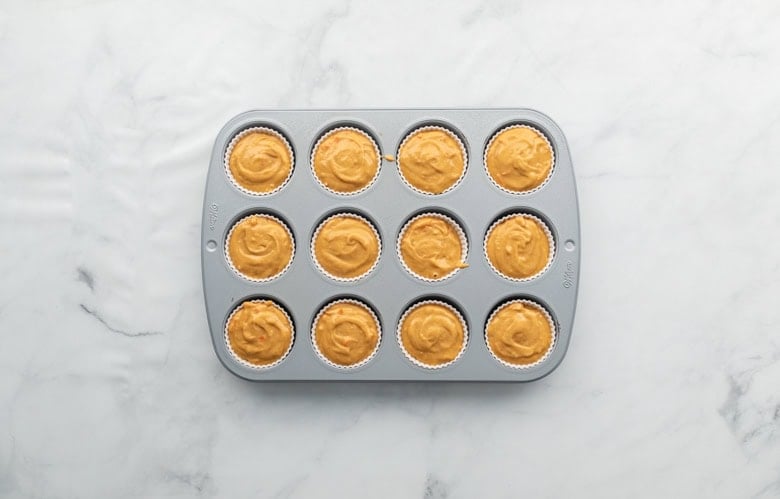 muffin tin with whole wheat pumpkin carrot batter