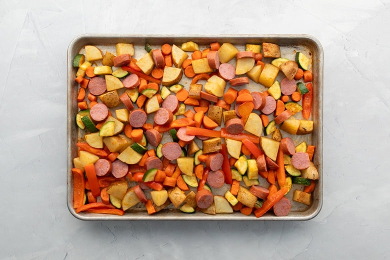 baking sheet with kielbasa, potatoes and veggies