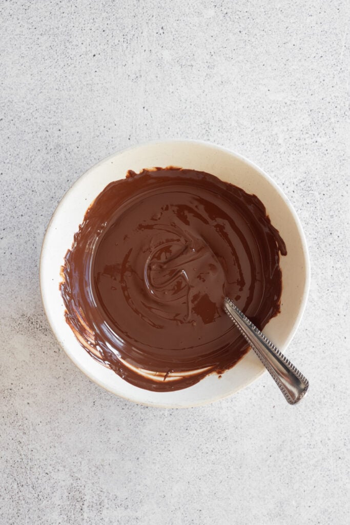 melted chocolate chips in white bowl for chocolate dates