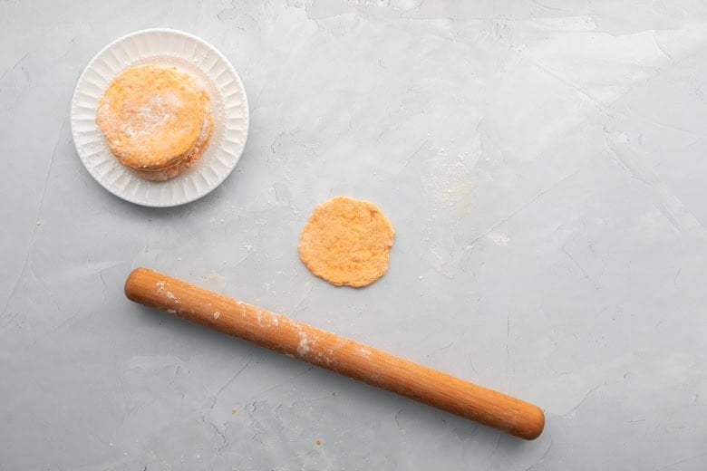 rolling pin rolling flatbread dough into a flatbread
