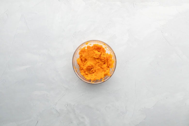 cooked sweetpotato mash flesh in clear bowl