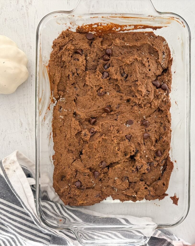 Baked pumpkin chocolate brownies in baking dish, cooling.