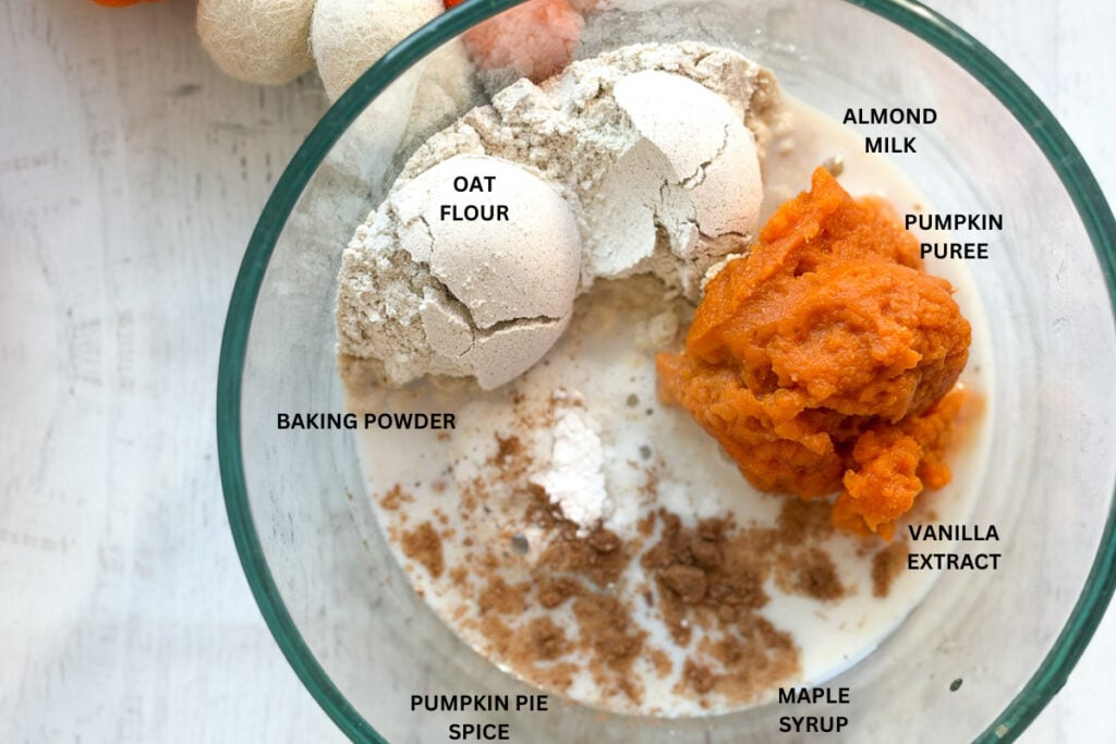 labeled ingredients for pumpkin mug cake in clear bowl