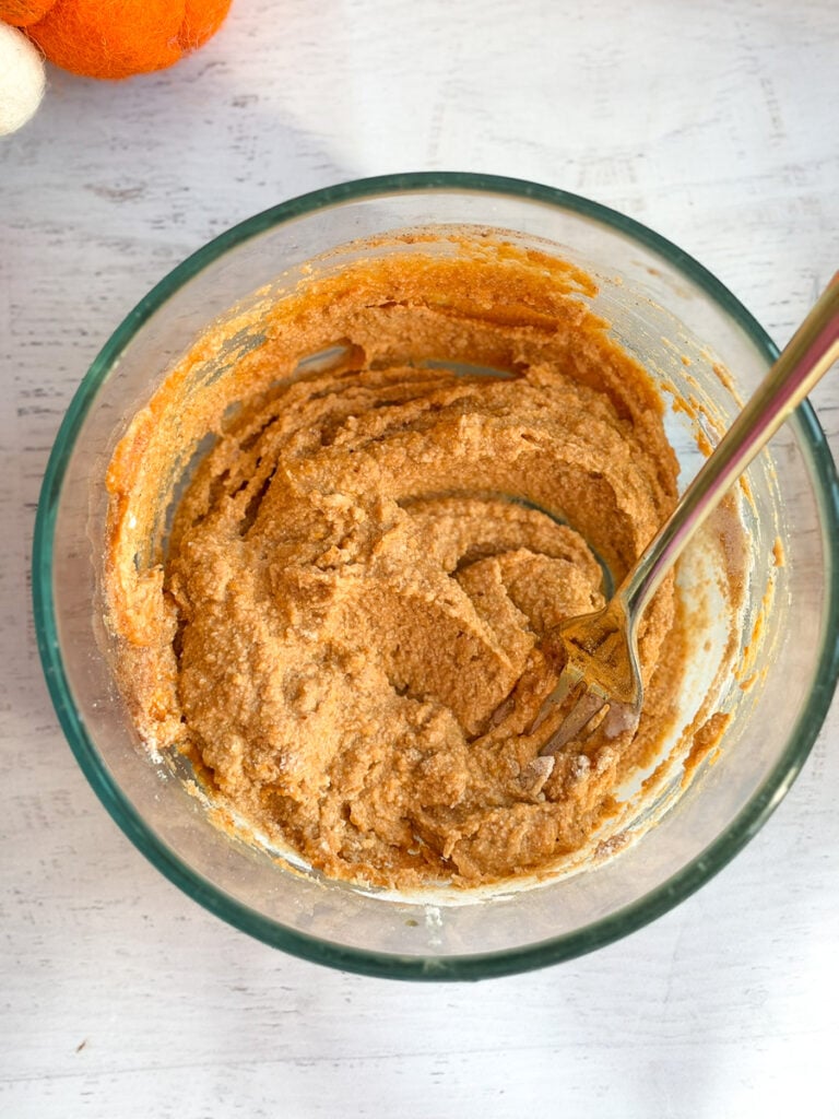 mixed ingredients in bowl for pumpkin mug cake