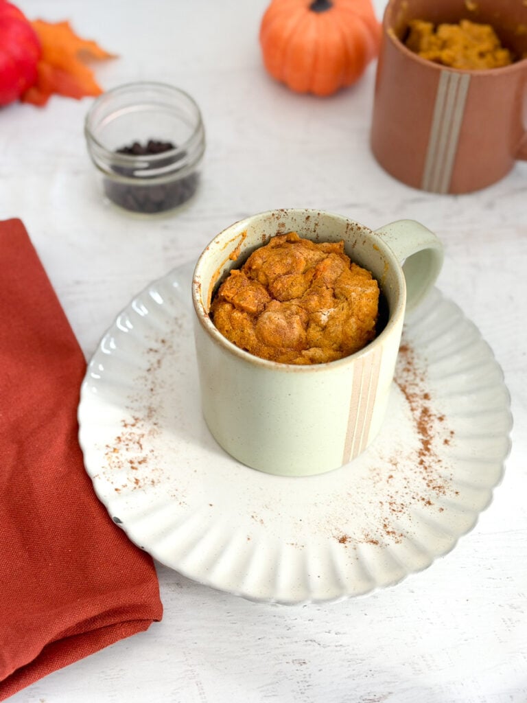 pumpkin mug cake in mug out of microwave